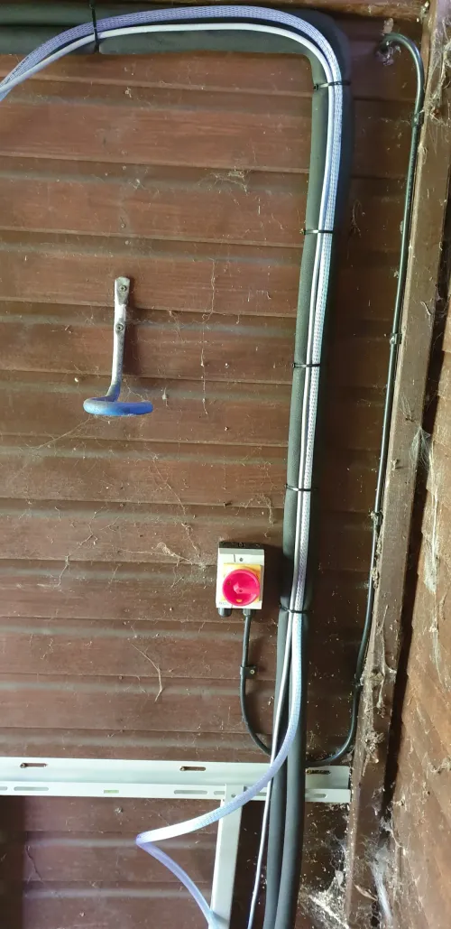 Exterior bracket with power cables for condenser