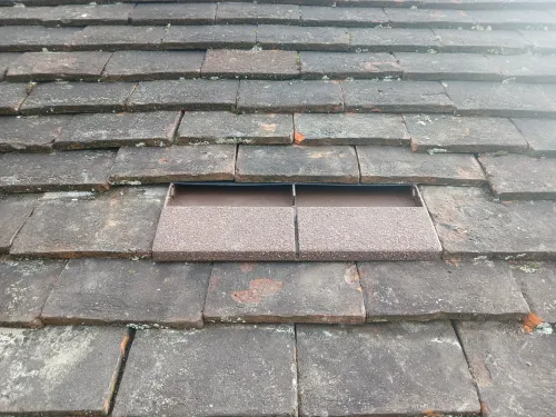 Tile roof outlet with hidden vent