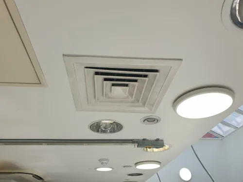 White outlet grille ceiling HVAC hairdressing studio