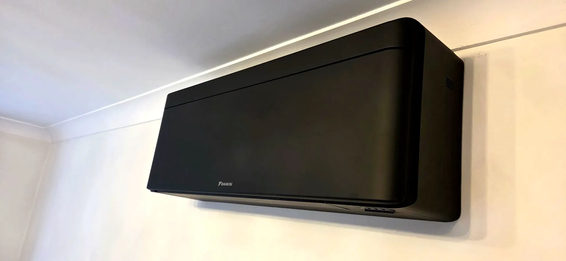 Daikin Emura black wall-mounted air conditioning unit installed by Ernest Air Cooling