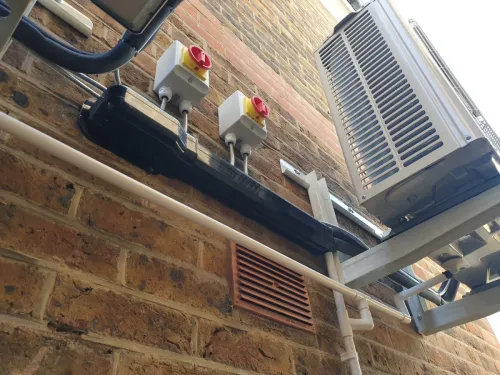 Mitsubishi air conditioning outdoor unit with isolators and black trunking
