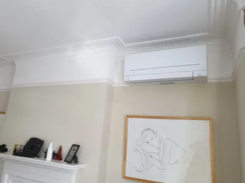 Victorian house with Mitsubishi air conditioning unit above picture rail