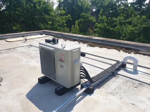 Mitsubishi outdoor multi-condenser rooftop installation in a Kingston home
