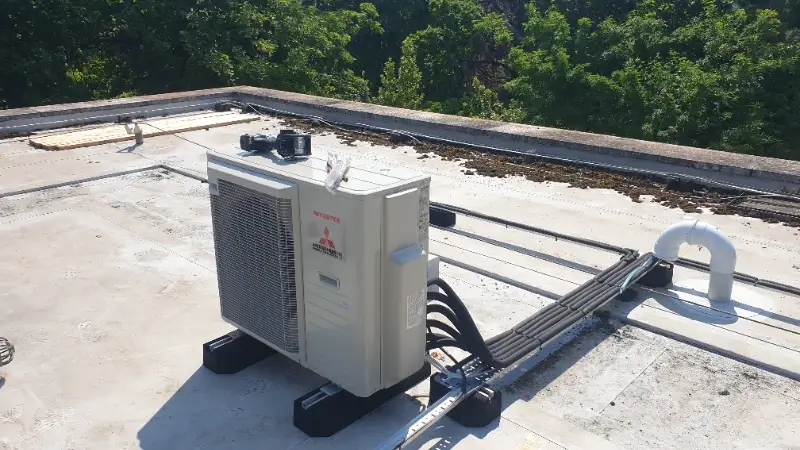 Cable tray system protecting AC lines on flat roof at Anna House