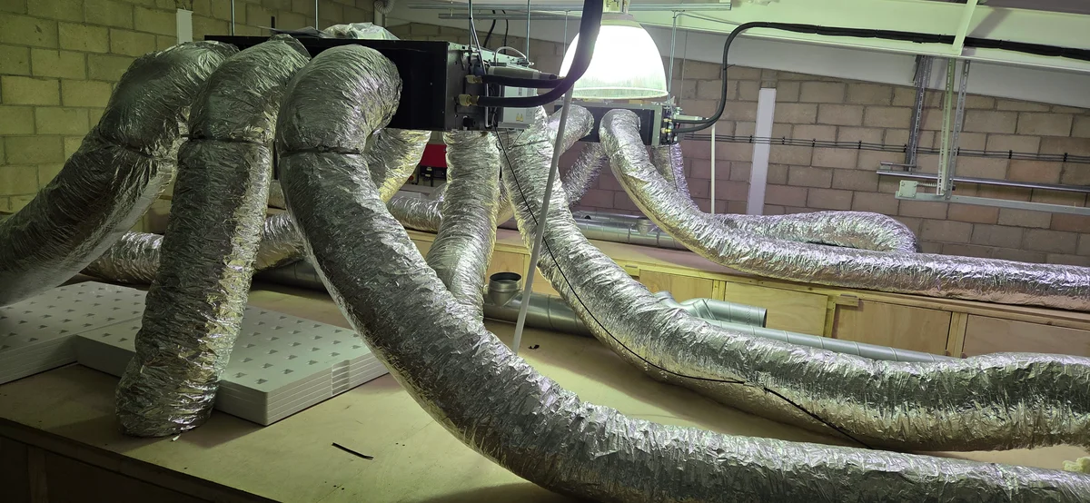 Mitsubishi Heavy Industries ducted air conditioning unit suspended above grow cabinet