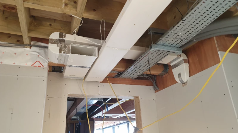 Concealed MVHR supply ducting installed in timber ceiling void of Sussex eco home