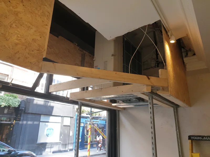 Internal Mitsubishi condenser unit housed within custom shopfront bulkhead