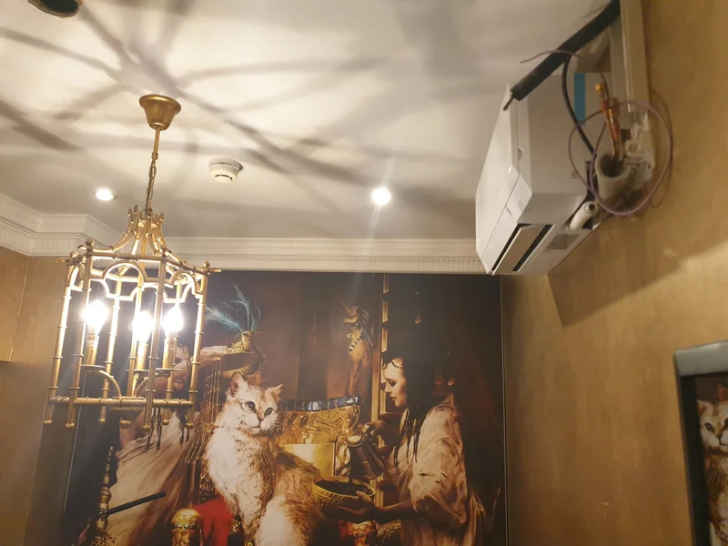 Mitsubishi Electric AC unit discreetly mounted in gold-finished treatment room